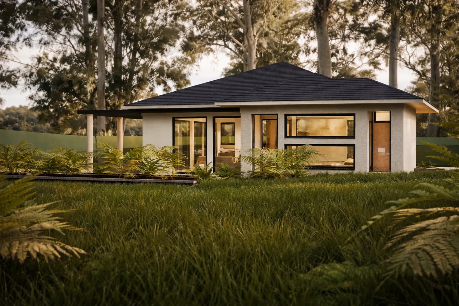 Sylvan rendering: single-story hip-roof house with black-framed windows and a covered terrace, set in a meadow beneath tall trees